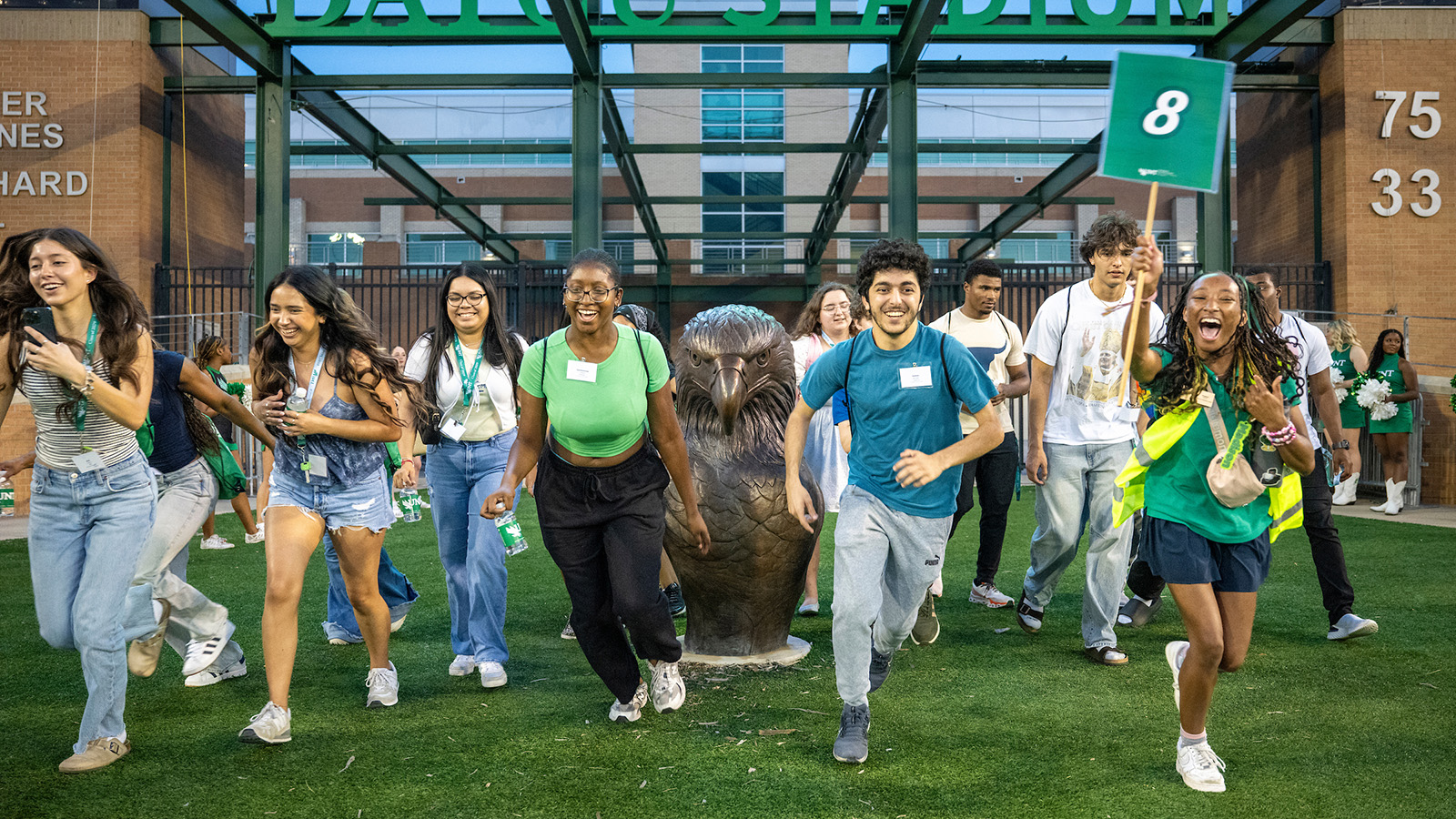 Students running into the DATCU stadium