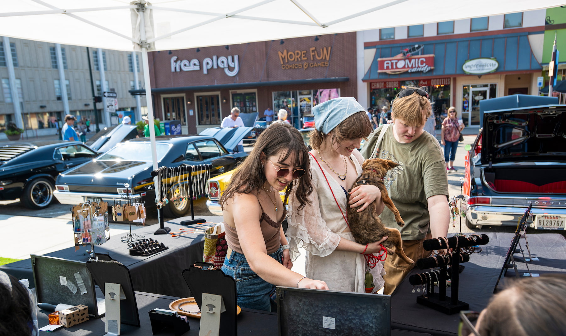 People looking at jewelry at an Arts and Auto event in Denton
