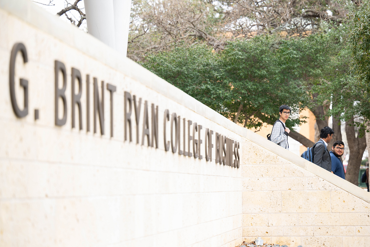 Students exiting the G Brint Ryan College of Business building on UNT's Denton Campus