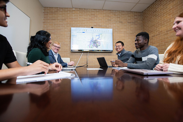 A group meets around a conference table
