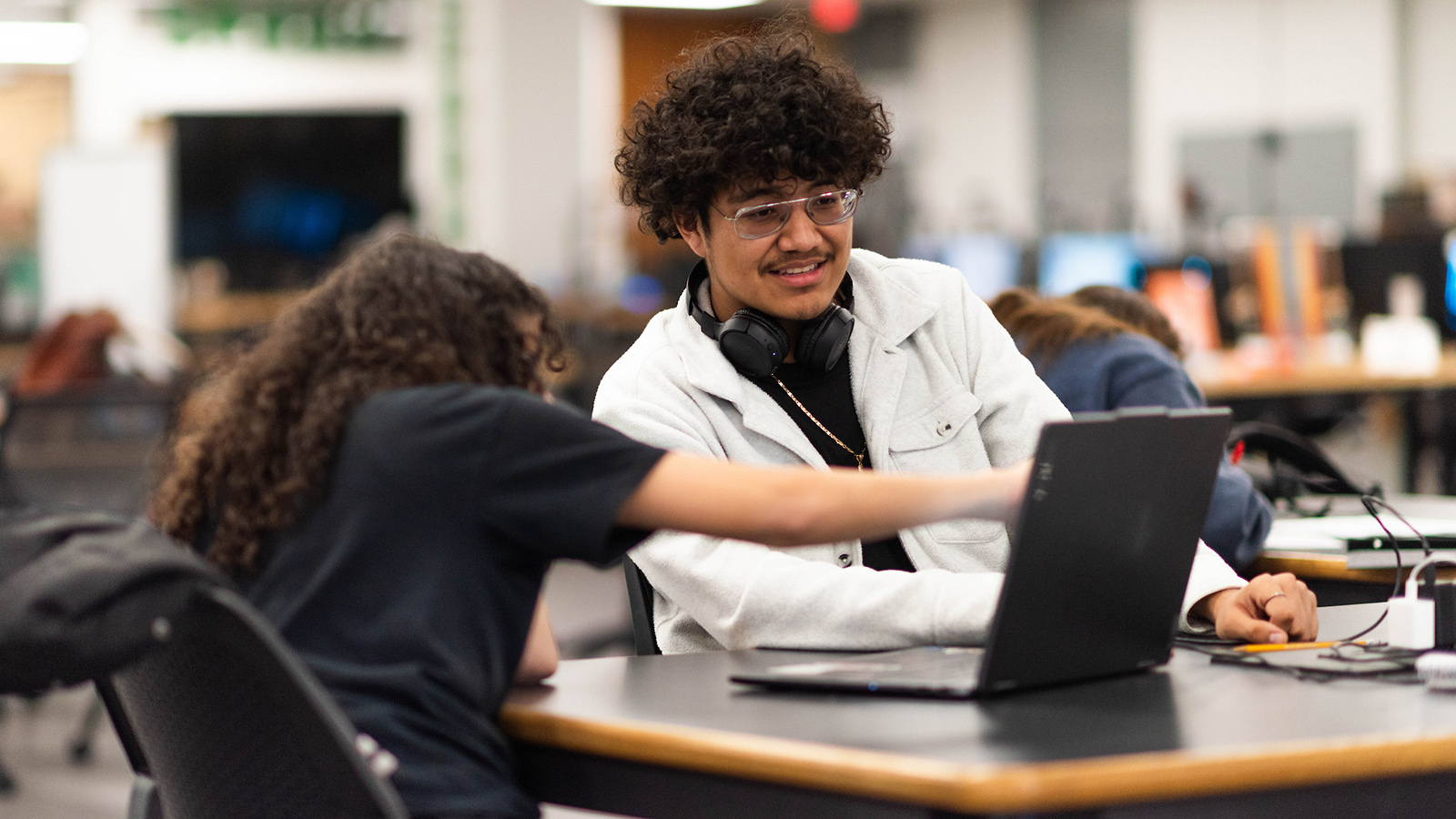 Students in the library working on laptops