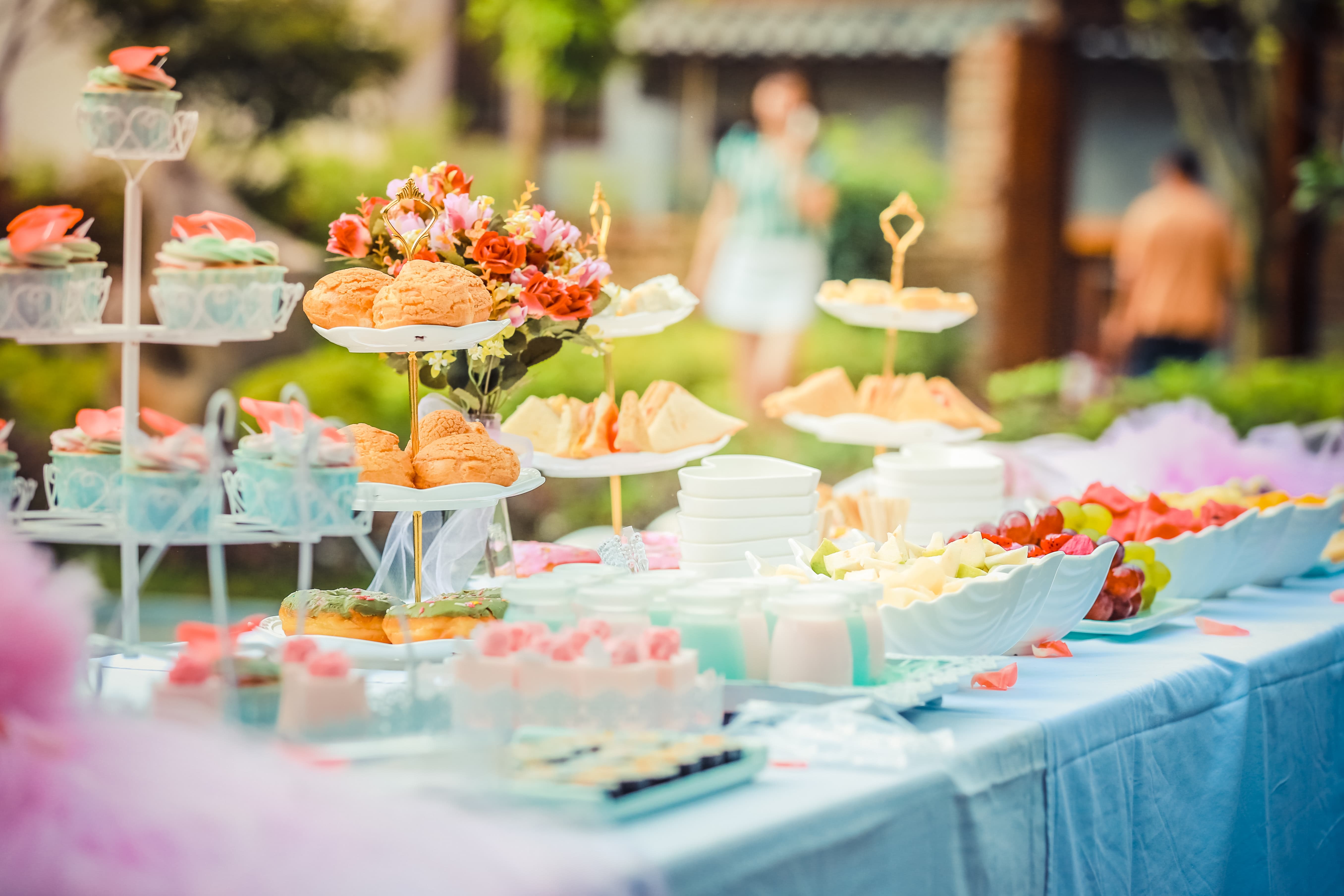 Afternoon tea service with finger sandwiches and cakes laid out on a buffet table