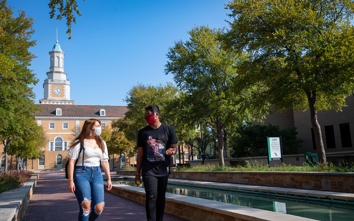 Studente walking in front of Hurley Administration Building