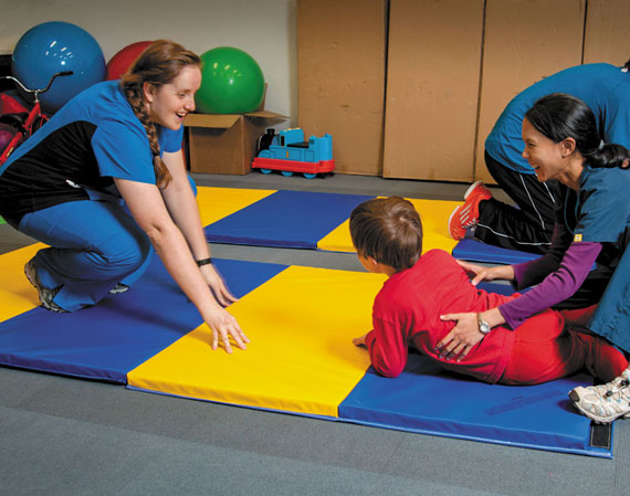 Students working with children at the Kirsten Farmer Center for Autism