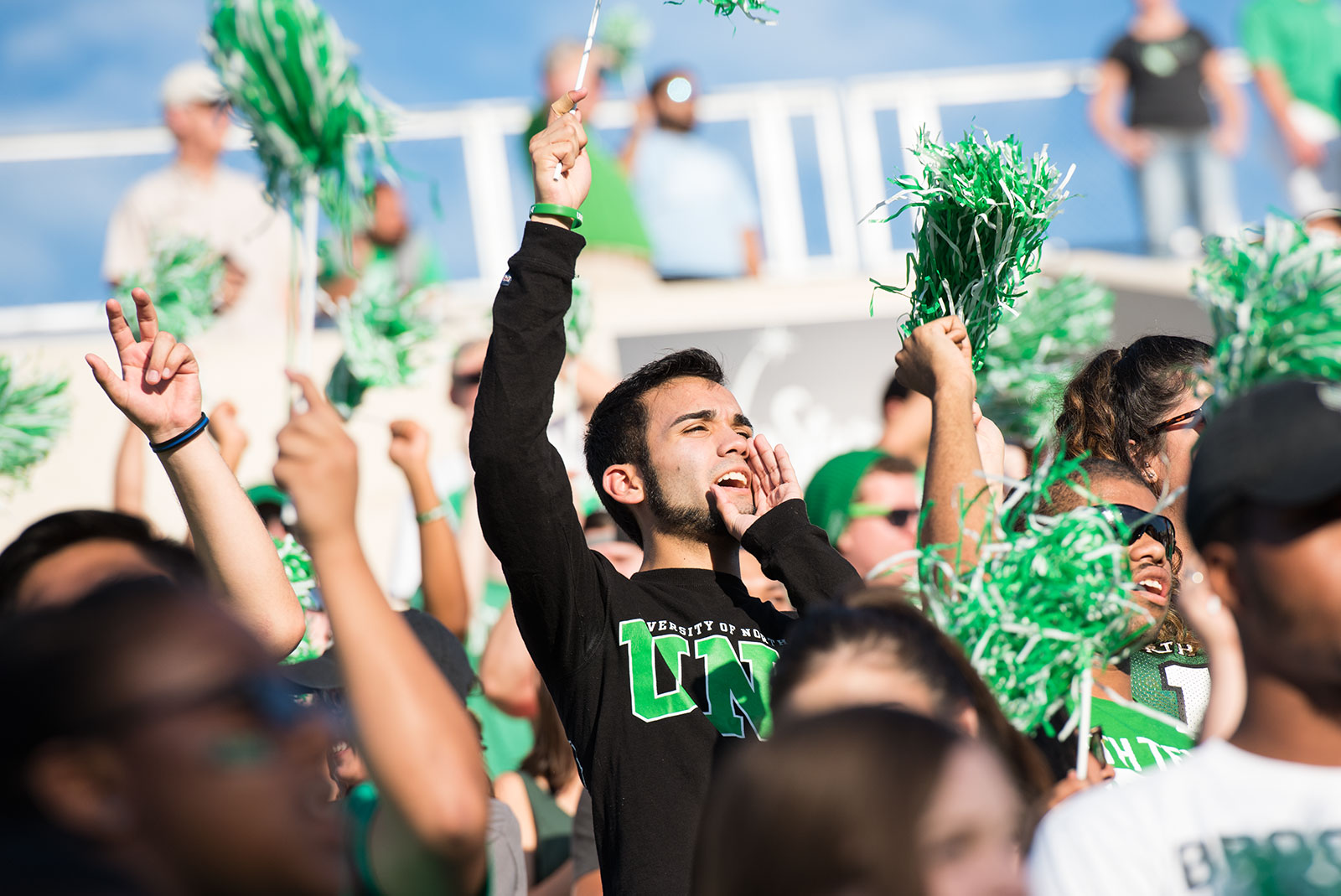 UNT students cheering at a football game.