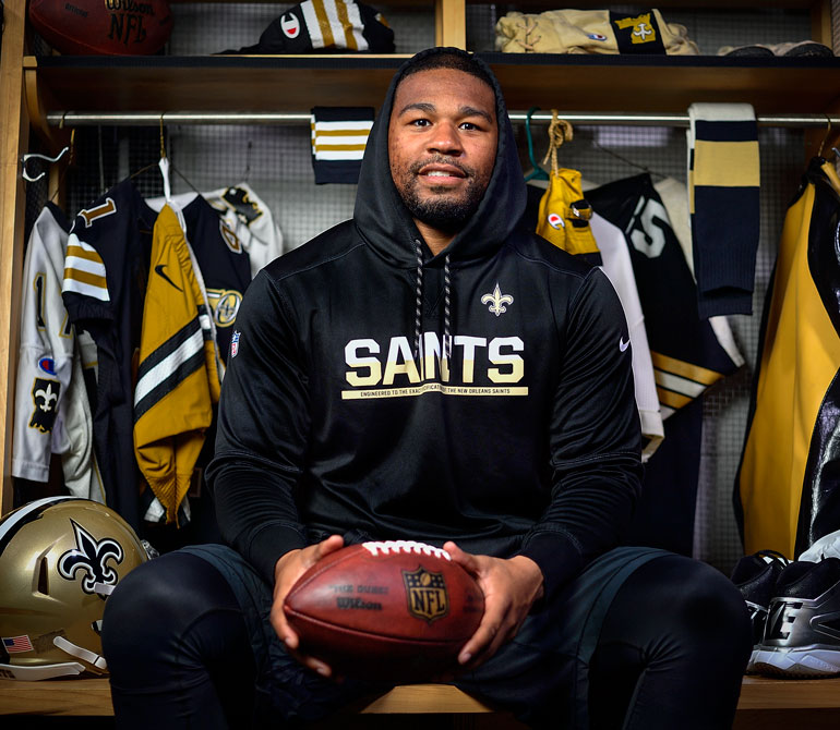 Alumni Craig Robertson in the New Orleans Staints locker room