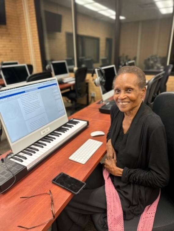 Joy Hague-Werst working at a desktop computer.