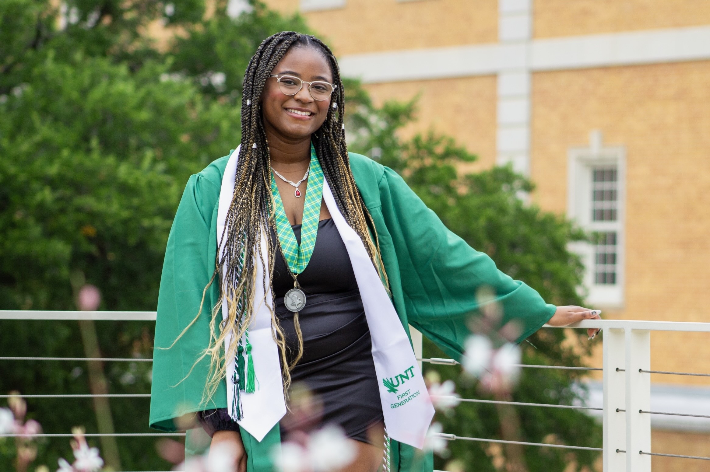 Lani Ahmed poses in commencement regalia on UNT's Denton campus