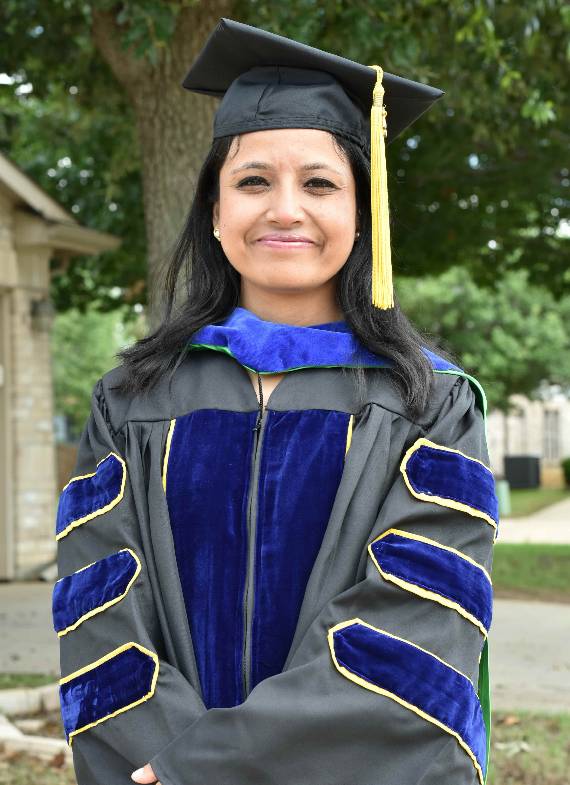 Photo of Moon Twayana wearing her cap and gown.