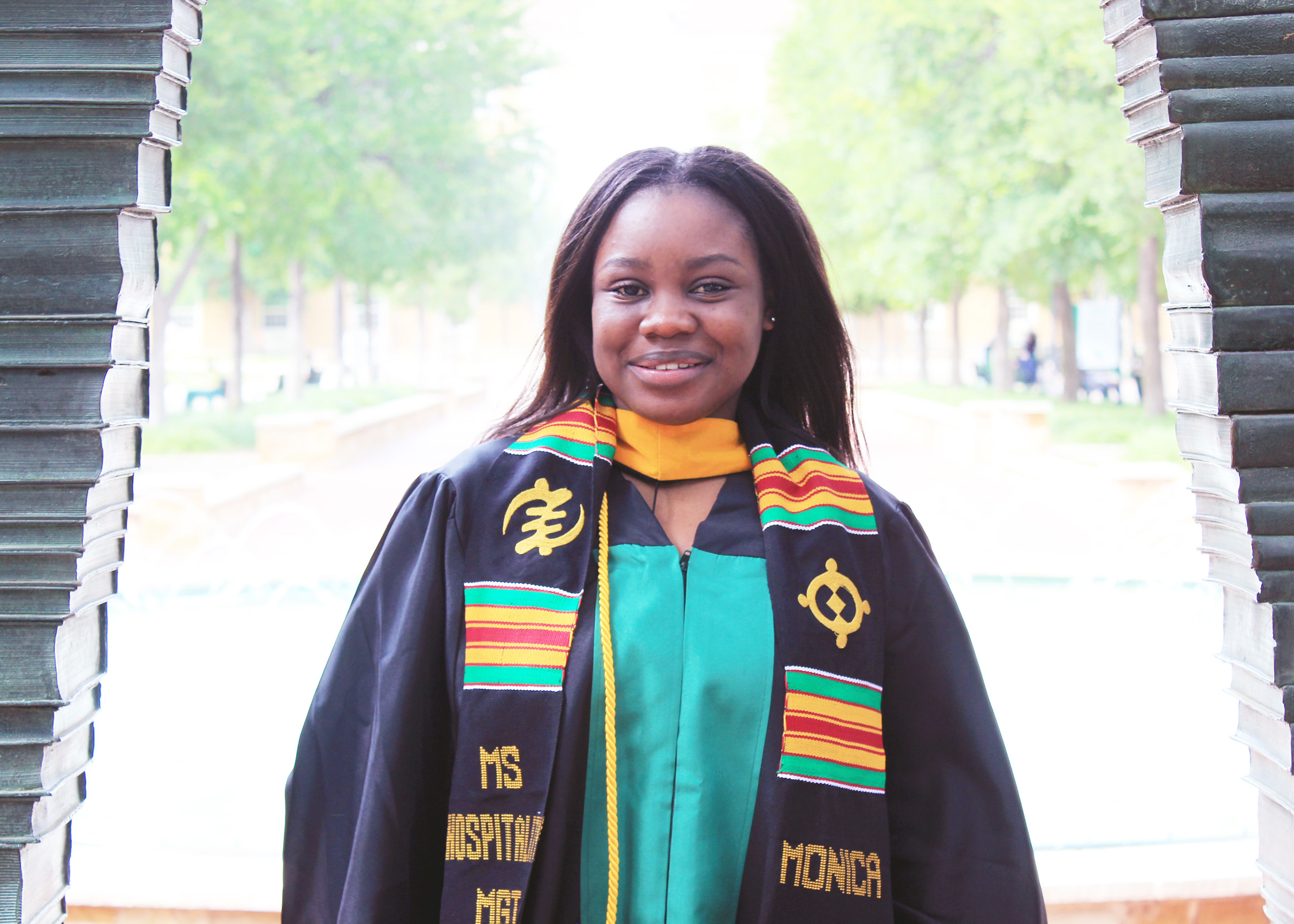 Monica poses in her commencement robes