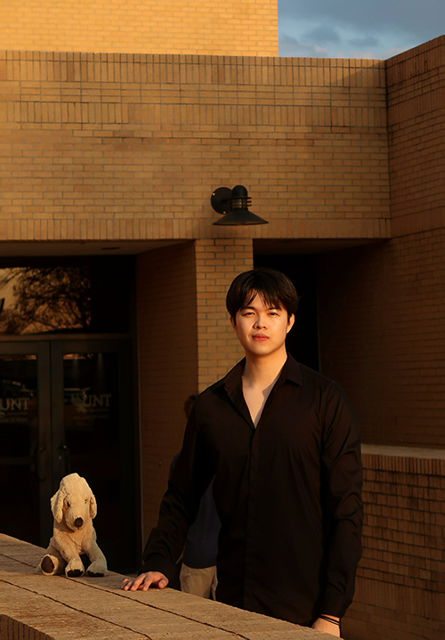 Qihang Lu poses in a modernist outdoor environment