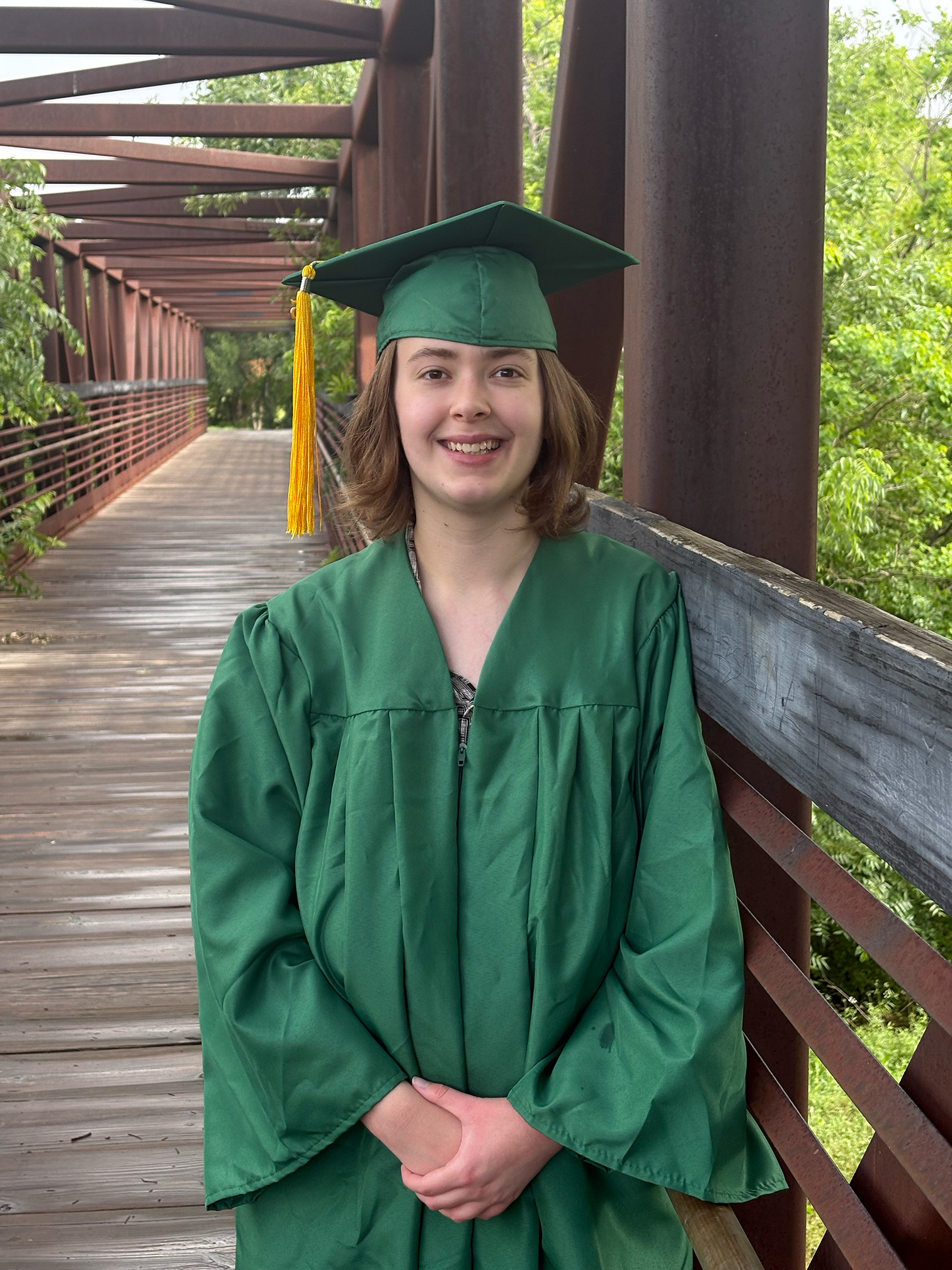 Rachel poses in commencement regalia