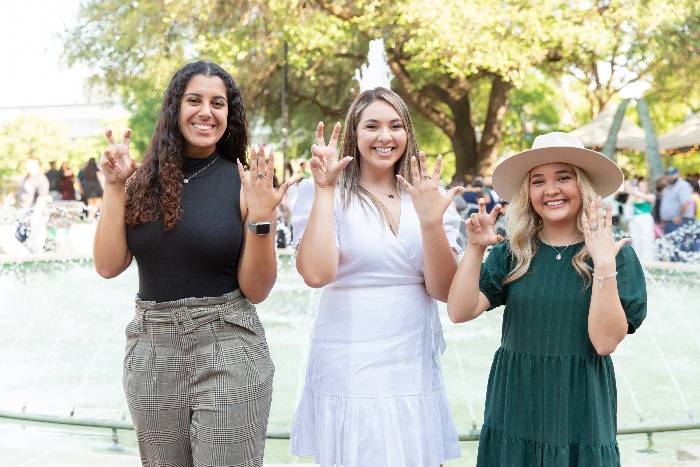 Students standing in front of a fountain in the Library Mall