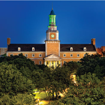 Hurley Administration building clock tower lit green at night