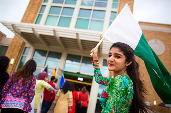 UNT student holding a flag at a cultural event. 