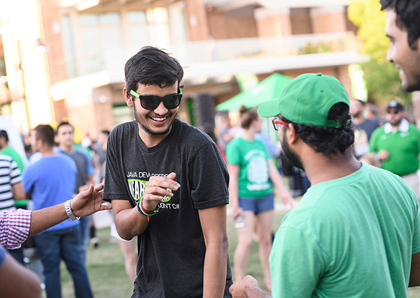 Two students enjoying the UNT preview event on a sunny day.