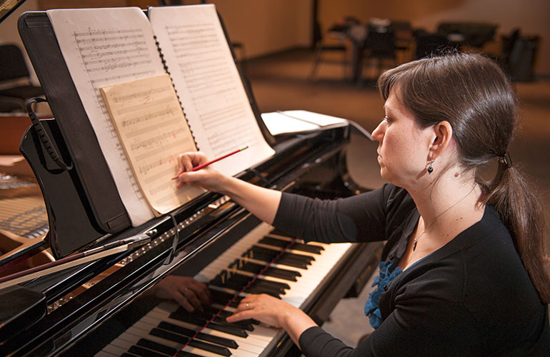 student composing at a piano.