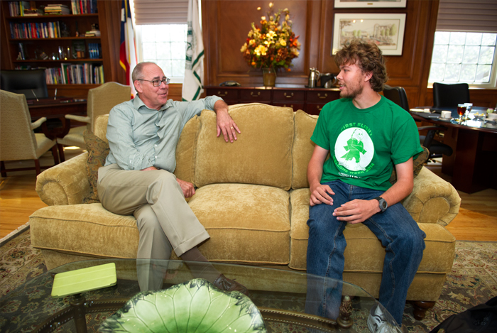 President sitting on a couch with a student