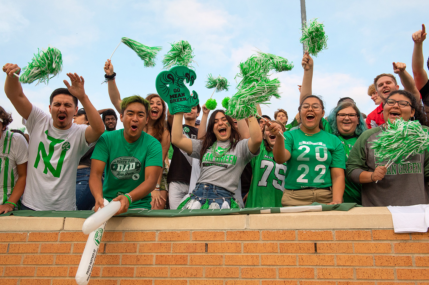 Students cheering at a UNT game