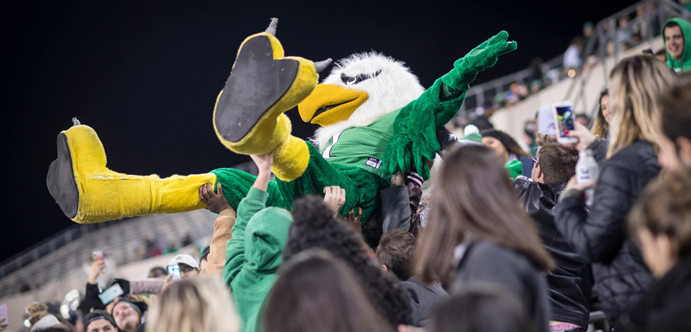 Scrappy crowdsurfing at a football game