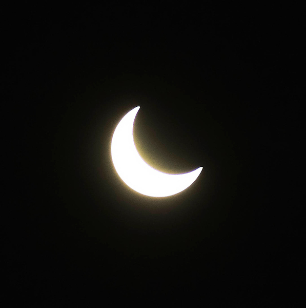 Image of the moon partially covering the sun during an eclipse