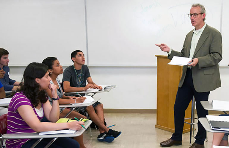 Honors College students in a classroom listening to a professor.