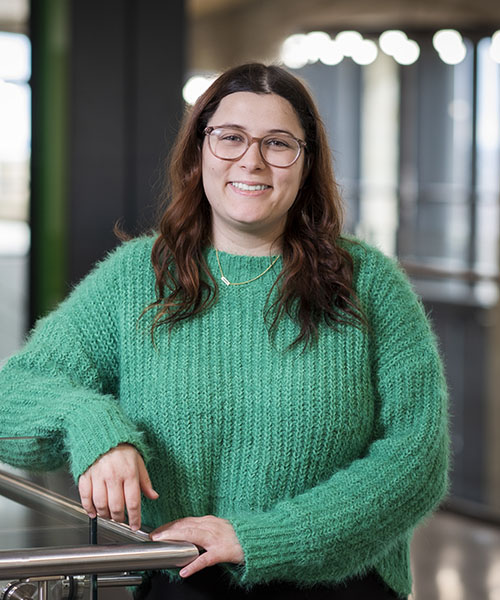 Woman wearing a green blouse smiling. 