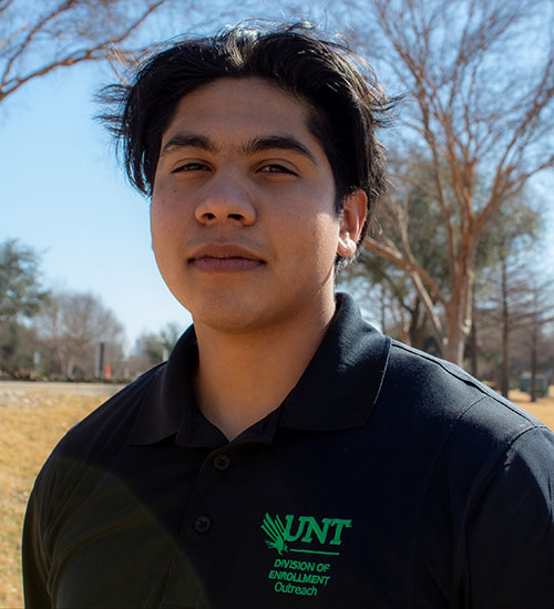 Man wearing black UNT shirt smiling. 