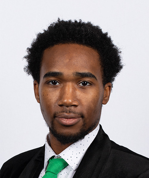 UNT admission recruiter wearing a black suit and green tie. 