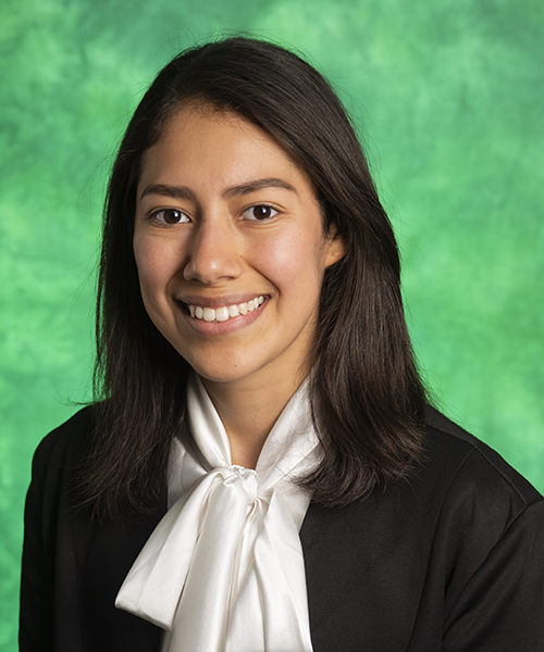 Woman wearing a white blouse smiling. 