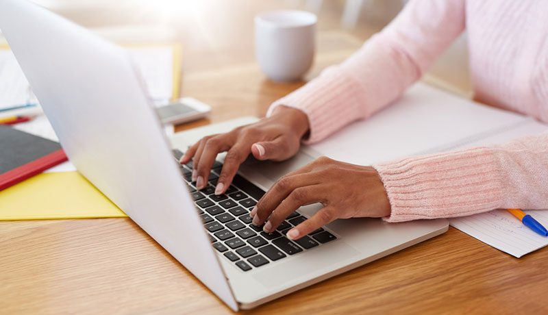 Person using laptop to access UNT Online