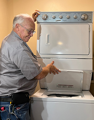 Maintenance worker with washing machine in the residence halls