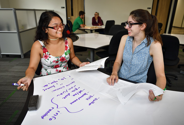 A student and tutor working at the Writing Center